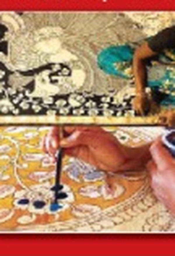 Artisan hand-painting Kalamkari cloth with a natural pen